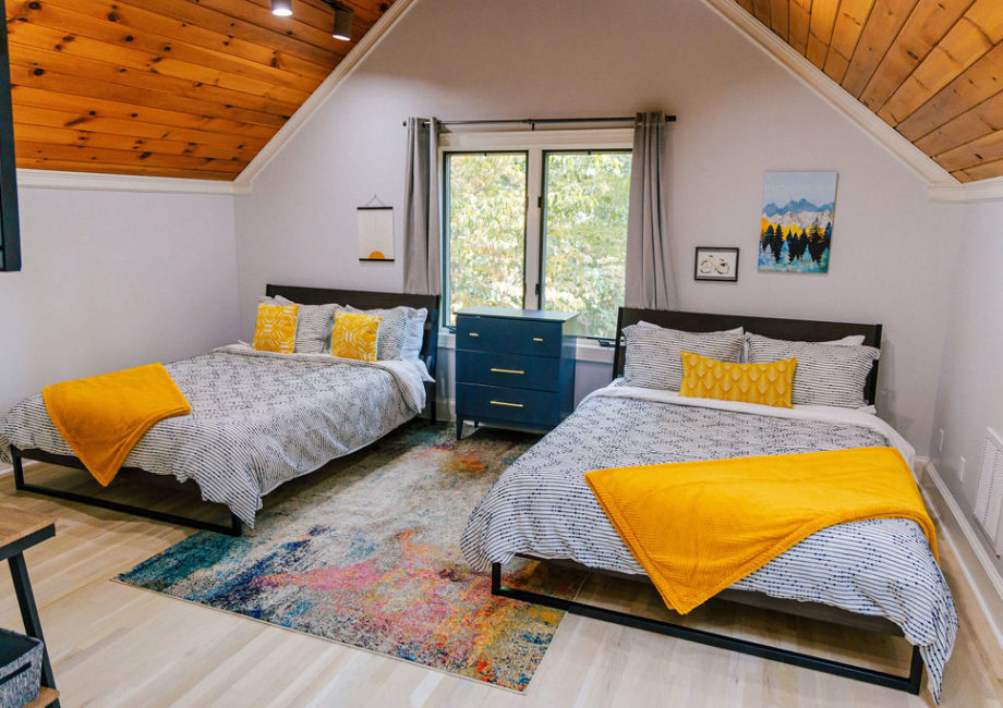 Second Floor loft bedroom with two Queen beds featuring medium/firm Latex/Memory Foam mattresses, organic sheets, and ample pillows. 35" Roku-equipped smart TV.