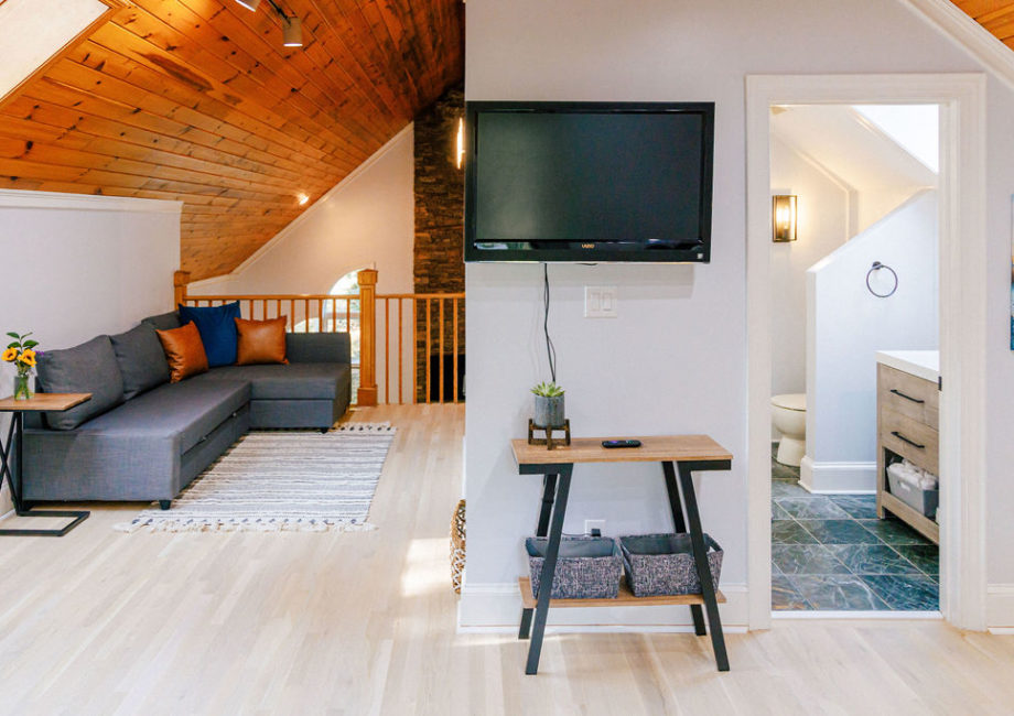 Guest bathroom off of second-floor loft bedroom features a walk-in shower and large skylight.