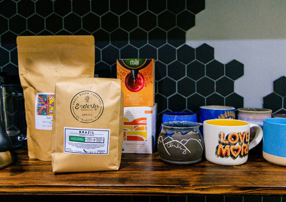 Coffee and tea station stocked with coffee essentials, local beans, and fun mugs, including locally-made pottery.